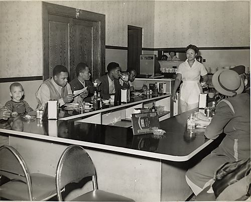 Lunch counter at the Centre Avenue YMCA, with Courier photographer Walter Allen seated