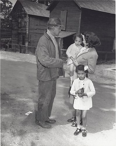 Woman with two little girls and a man in the street