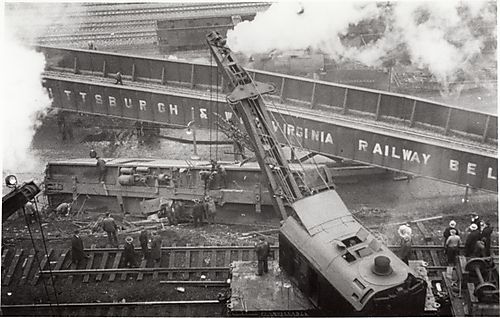 Workers with crane attempting to right freight car near Pittsburgh &amp; West Virginia Railway