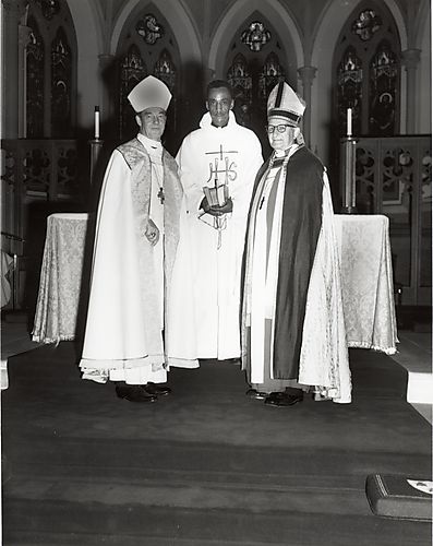 Three priests at an altar