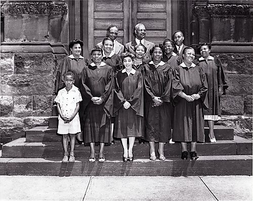 Women's choir with boy, two men, and minister in rear, at a church in Braddock