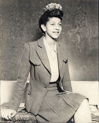 Young woman in tweed suit with bow in her hair