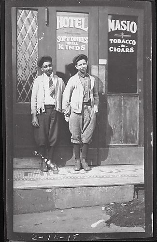 (2 boys standing outside Hotel Masio)