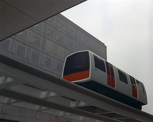 Sky Train on Rail in Front of Office Building