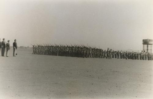 Bystanders Watching Soldiers with Rifles