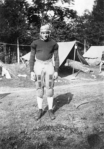 Portrait of "Ned" Newbaker with football helmet