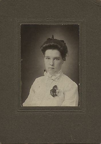Portrait of a young girl in a white dress with a corsage