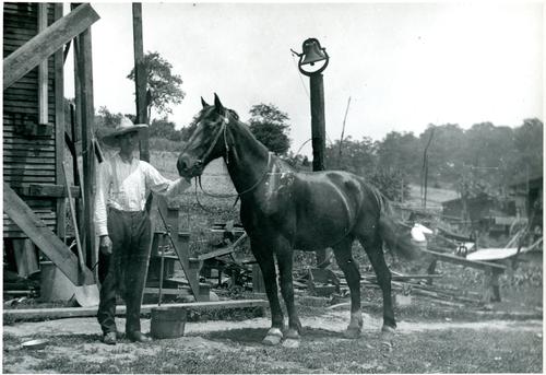 Albert Denny with Horse in Front of House Construction