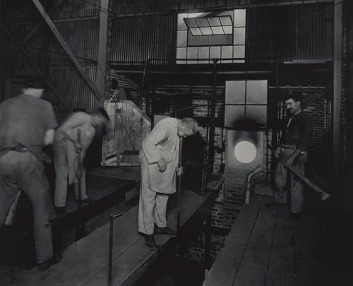 Glassblowers hand-blowing glass