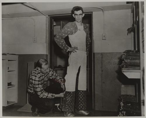 Glass cut-off man being fitted in safety gear
