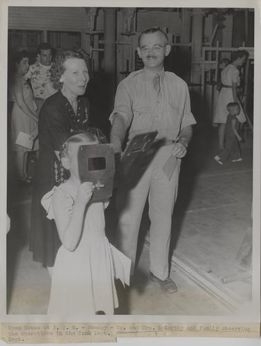 Family member of employee observing operations in the tank department at an open house