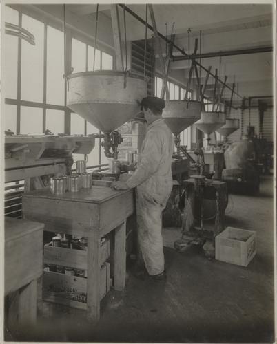 Employee silling paint by weight and measure