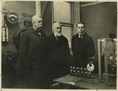 George Westinghouse, Lord Kelvin, and Charles Merz viewing an exhibition of the Hewitt Static Converter
