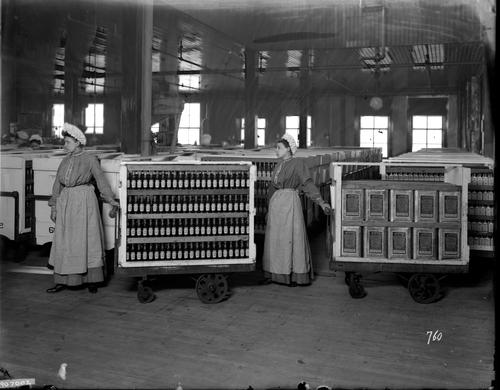 Heinz employees pulling carts of olive oil 