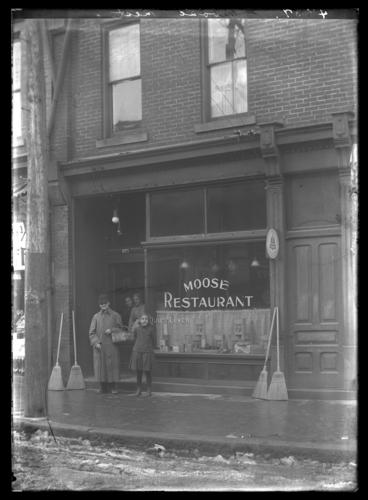 Blind man with brooms outside Moose Restaurant