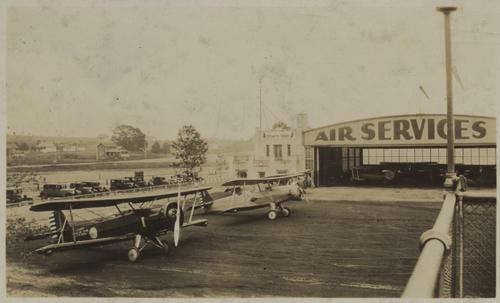Unidentified airfield and airplane hangar