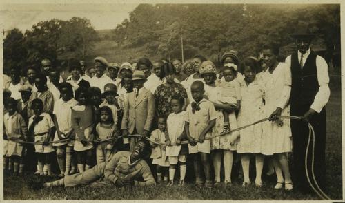 Family and friends posing with tug of war rope