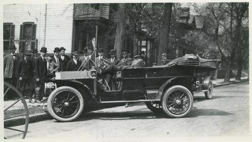 Crowd Gathered Around an Automobile