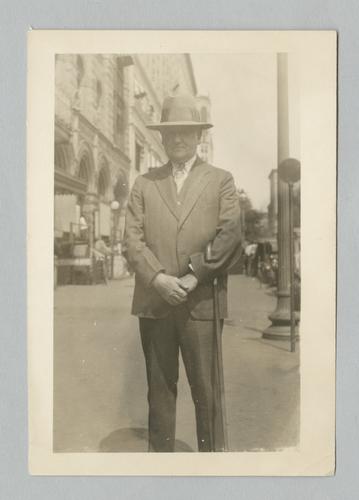 Dr. Stanley M. Rinehart outdoors in suit and hat