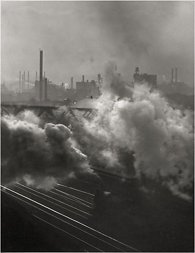 (smoke rising from train with factories in background, Pittsburgh, PA)