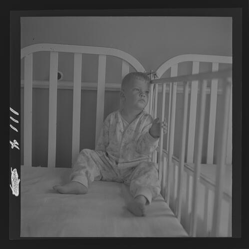 Child Sitting in Crib