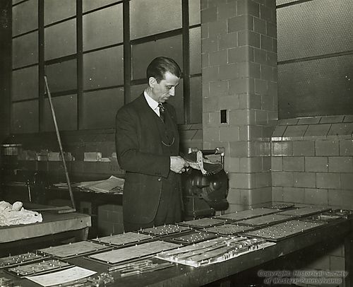 South Vocational High School Instructor Examines Airplane Parts