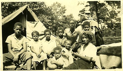 Zerbie Ella Dorsey and children in front of a tent at Sideling Hill Summit.