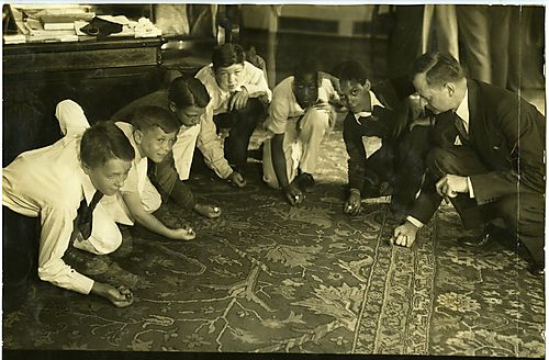 A group of children playing marbles