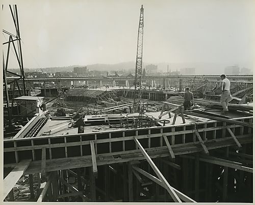 Two workers at the Civic Arena construction site